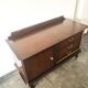 Dark wood sideboard with brass finishes and compass feet