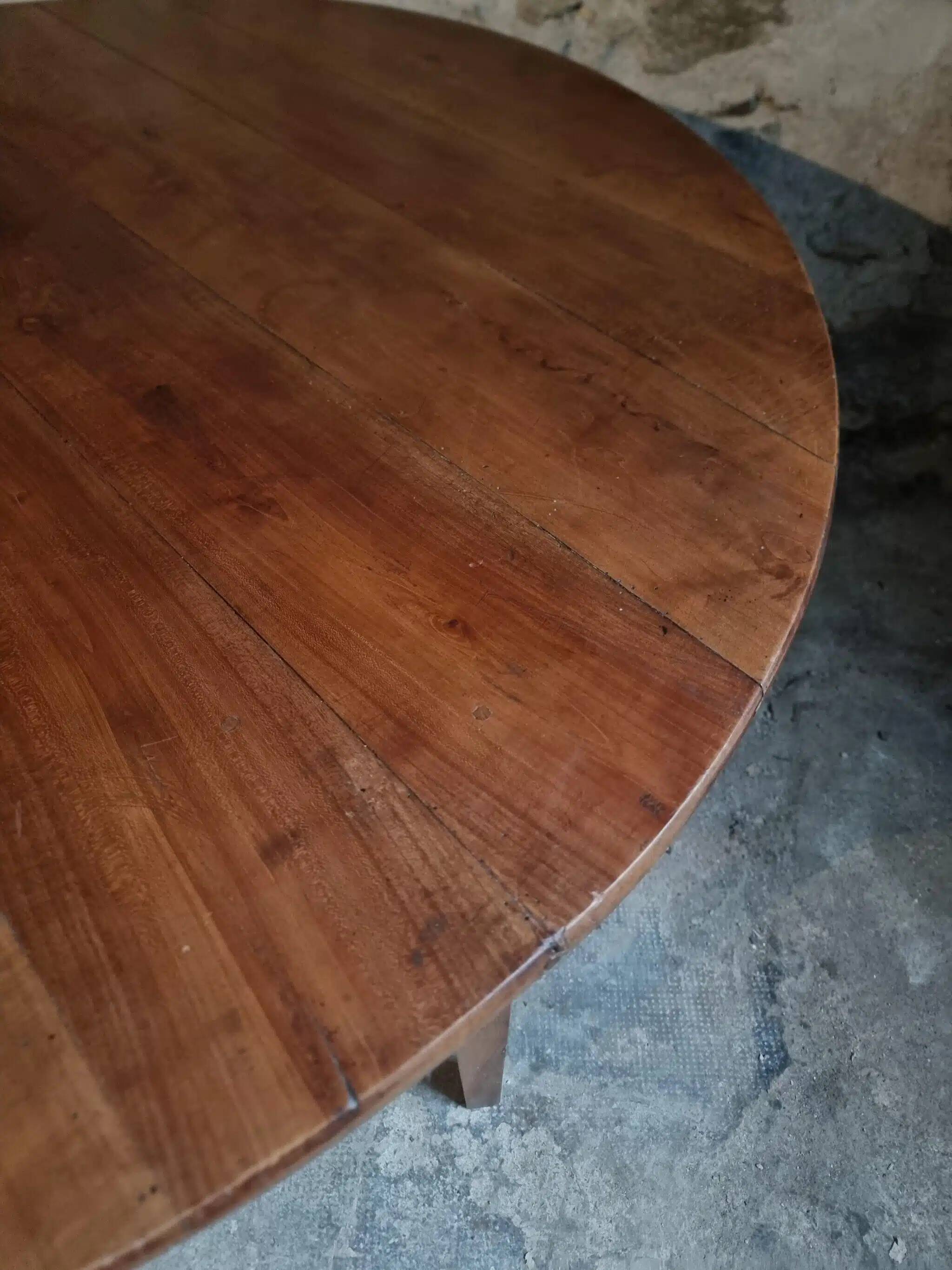 Antique round dining table in cherry wood, France, circa 1920.