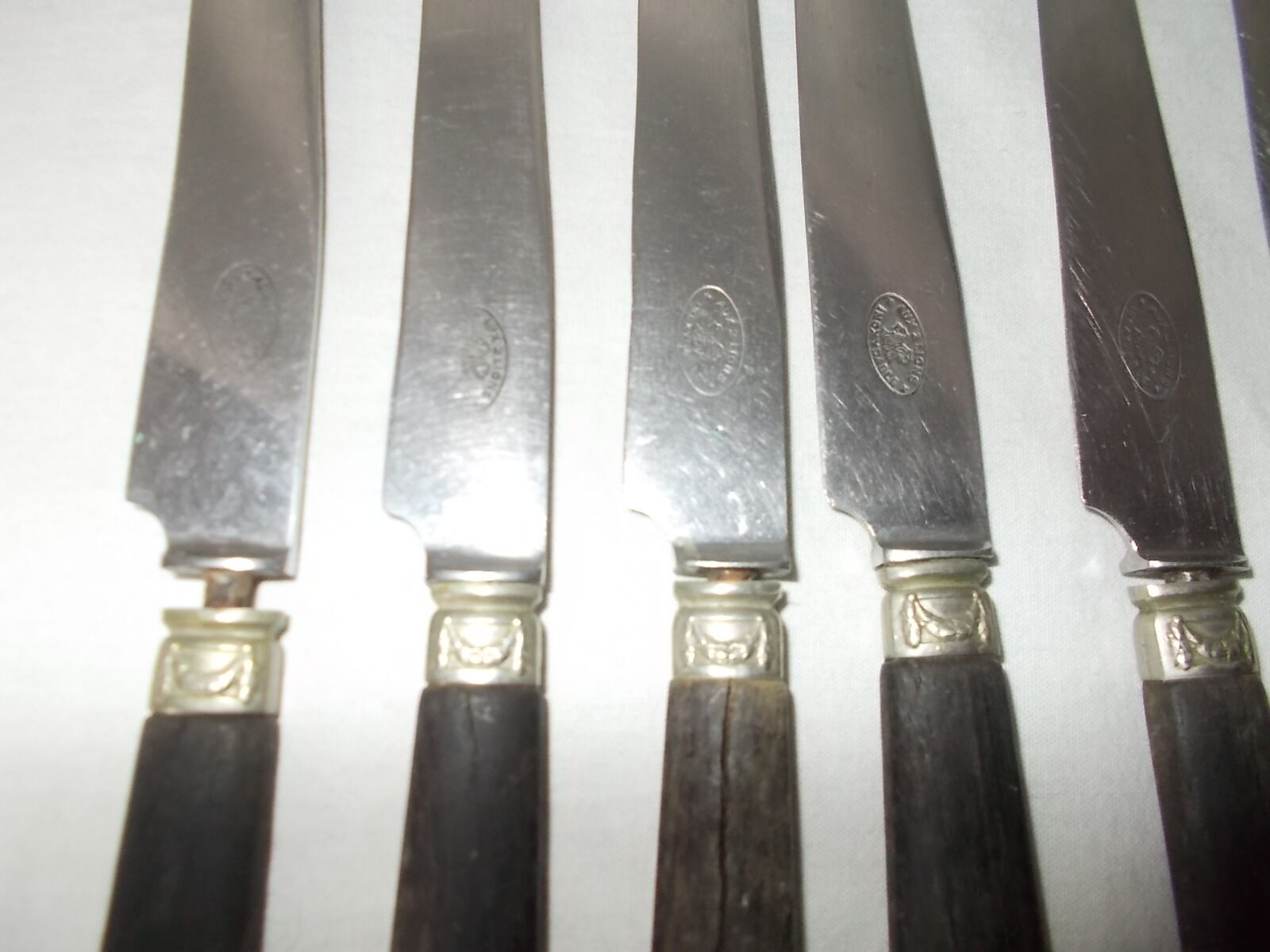 Set of 11 black wooden sleeve knives