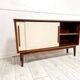 Mid-century teak sideboard with white synthetic doors.