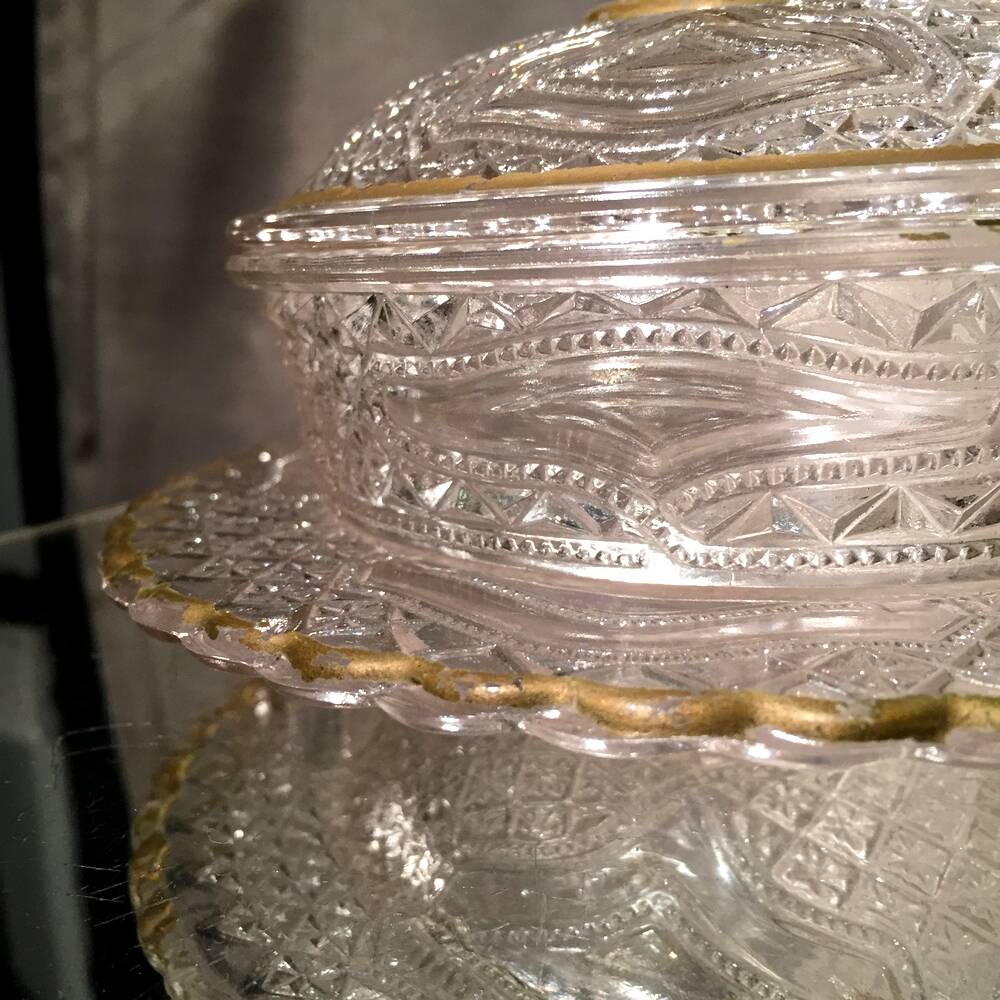 Butter dish or candy dish in pressed glass molded with golden rim