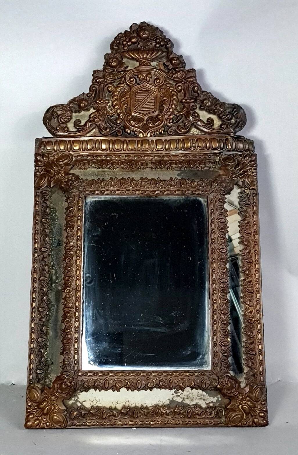 Antique brass repoussé mirror with wooden backing, 59x31 cm, C831.