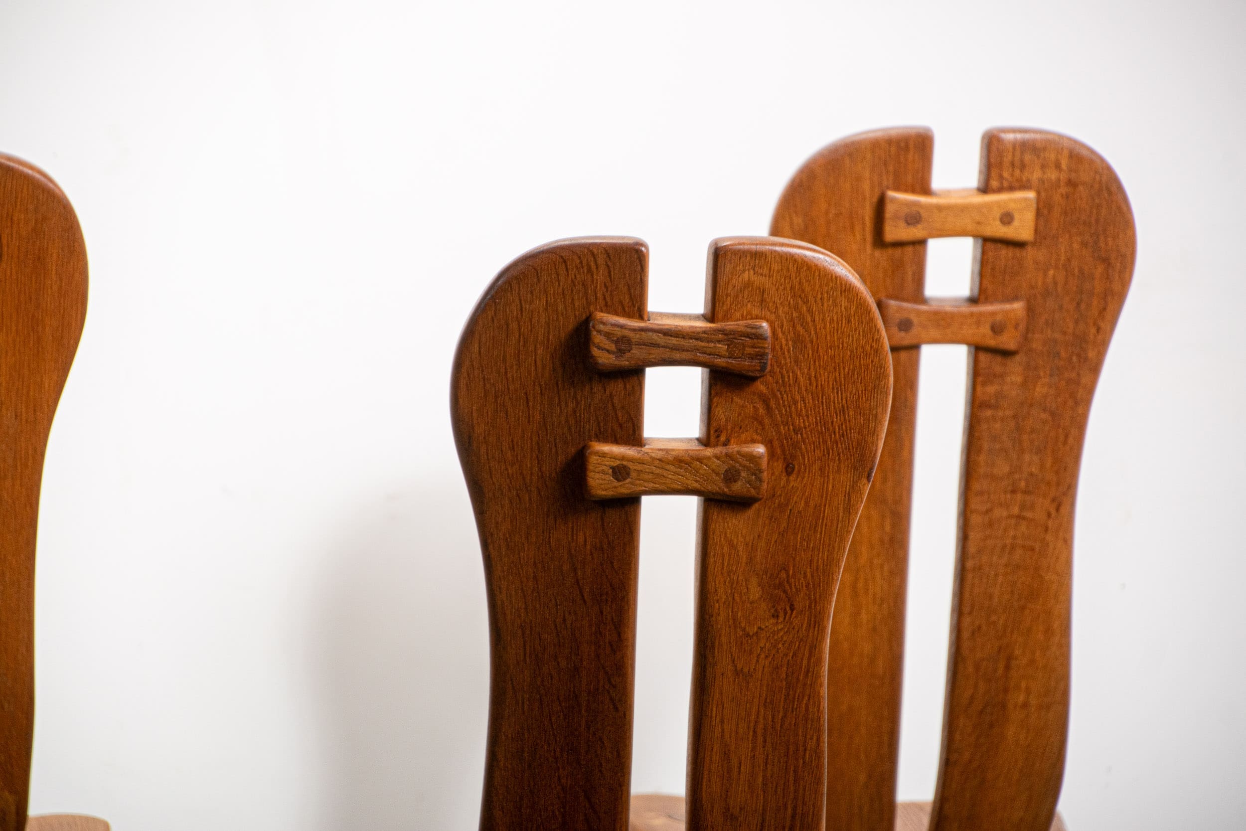 De Puydt brutalist dining chairs in solid oak. Circa 1970.