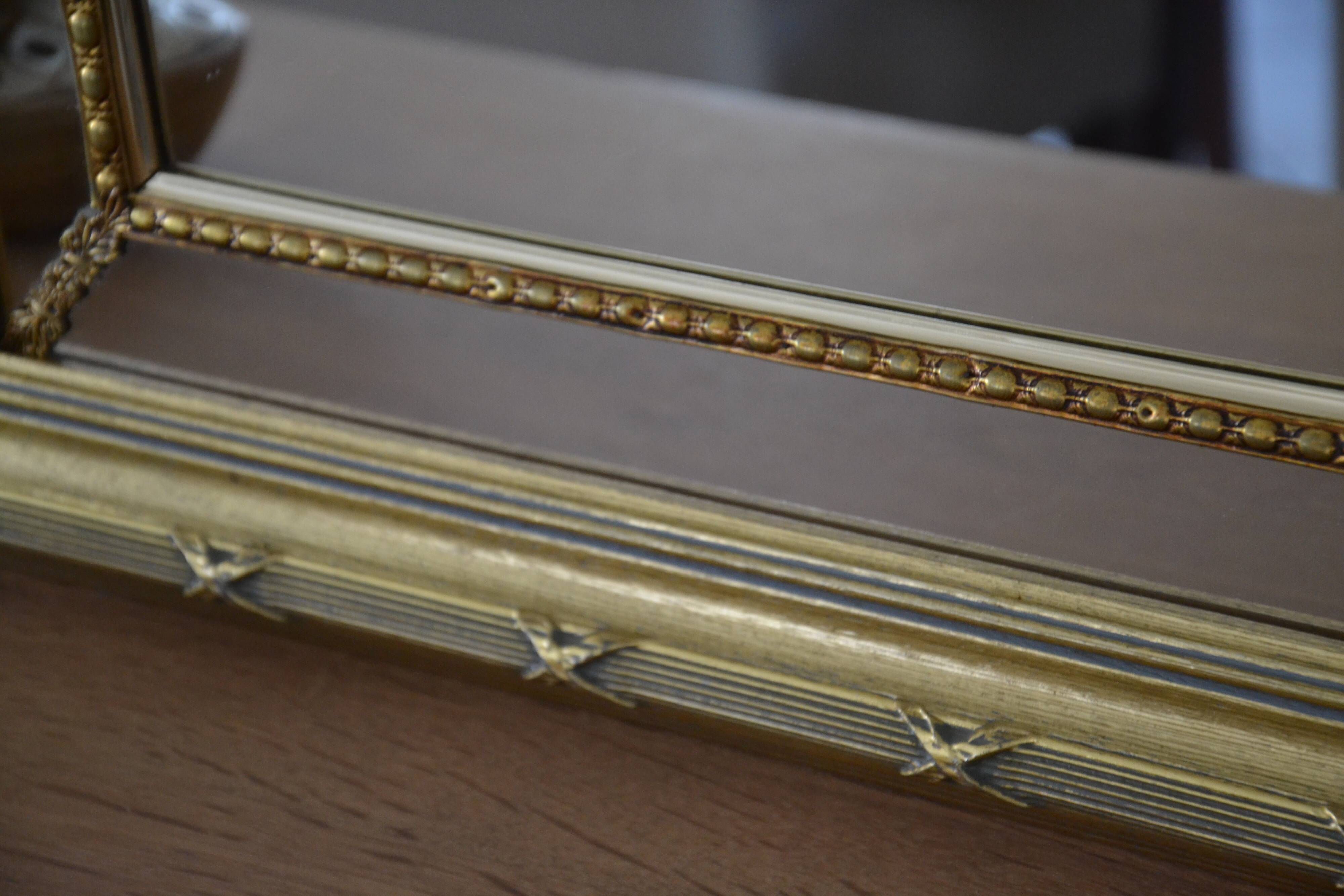 Large mirror with wooden gilded and carved frame.