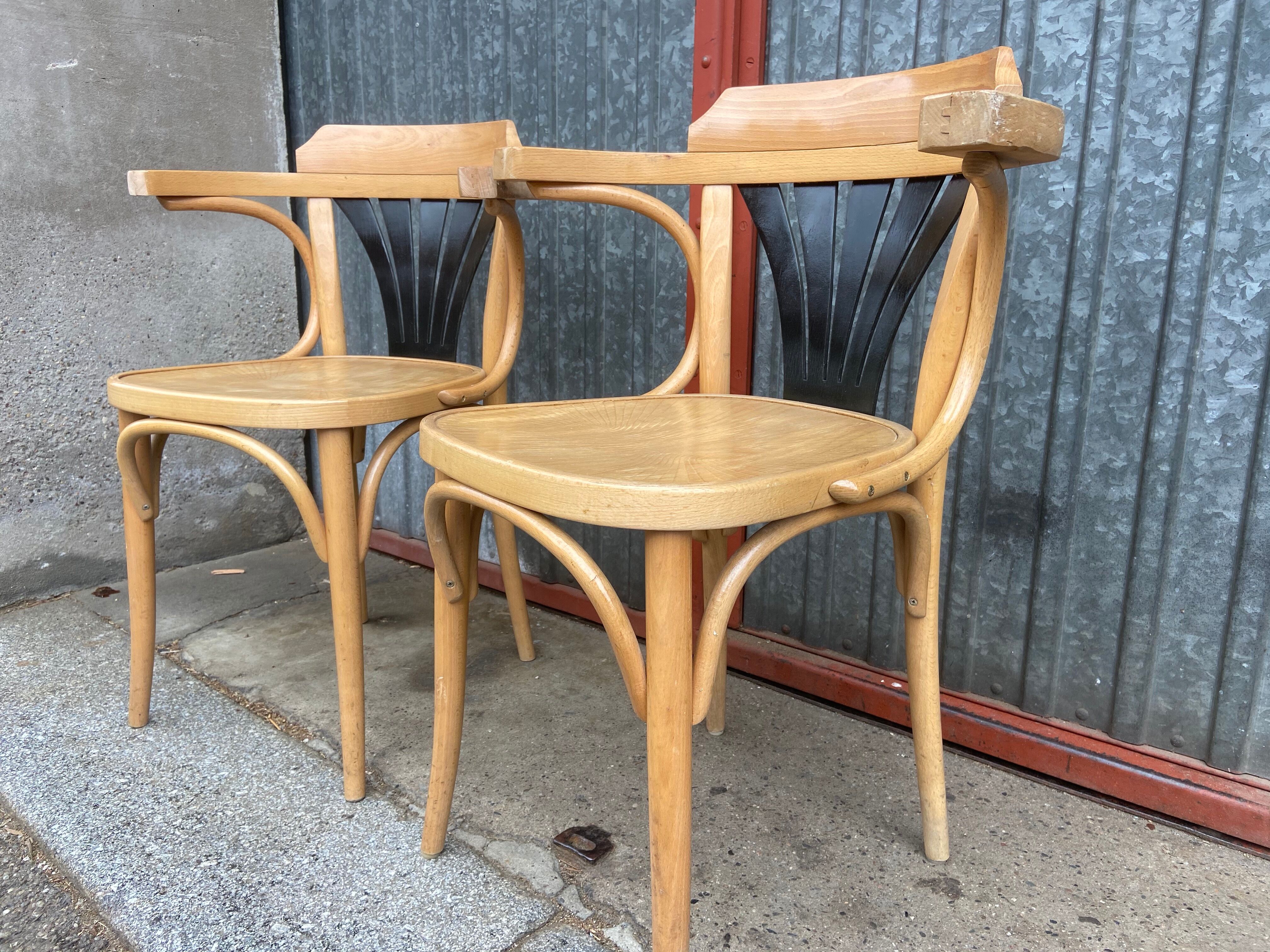 Pair of curved wooden bistro chairs with armrests