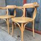 Pair of curved wooden bistro chairs with armrests