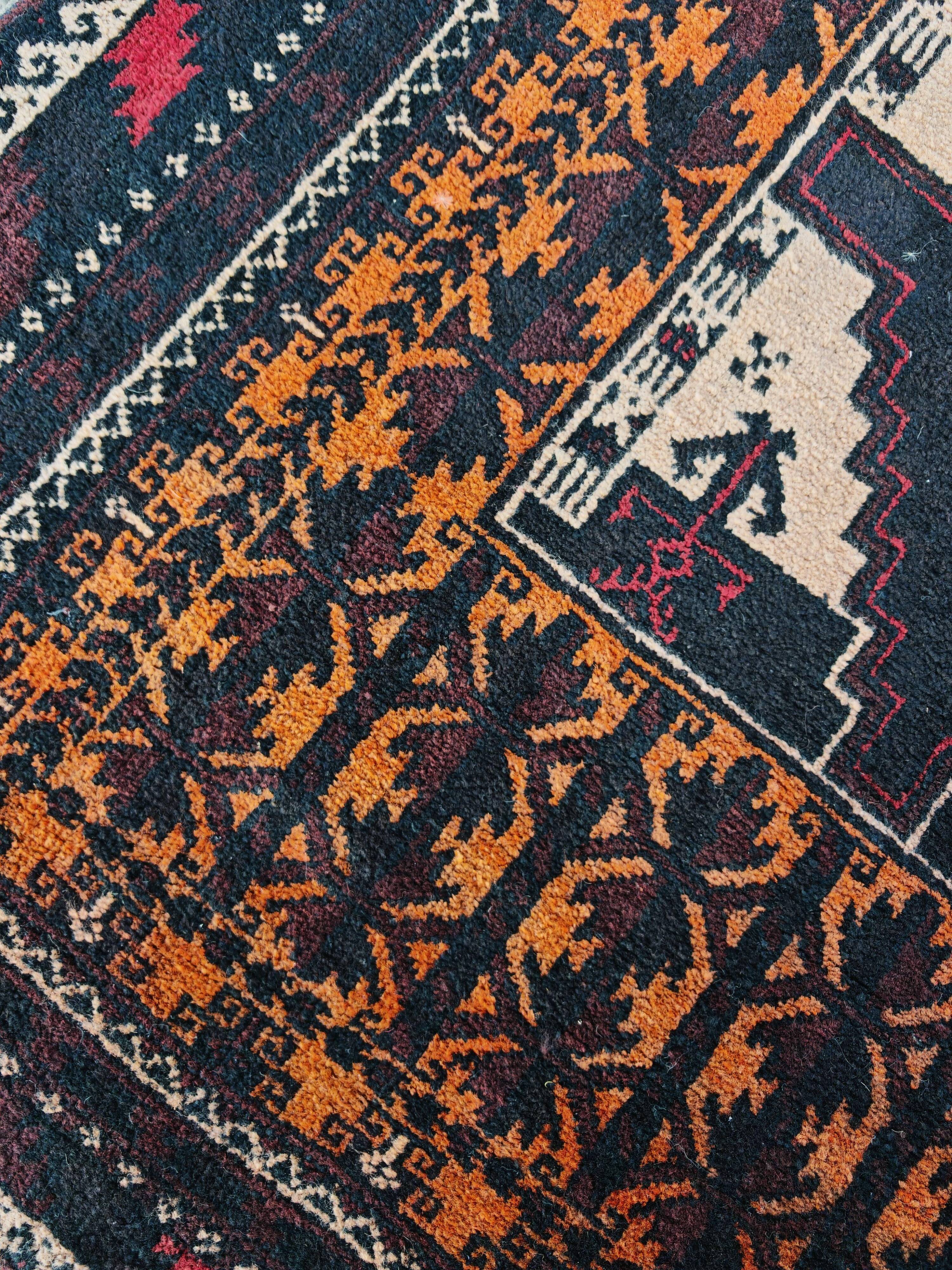 Vintage Persian Baluch rug, hand-knotted wool, 1970.