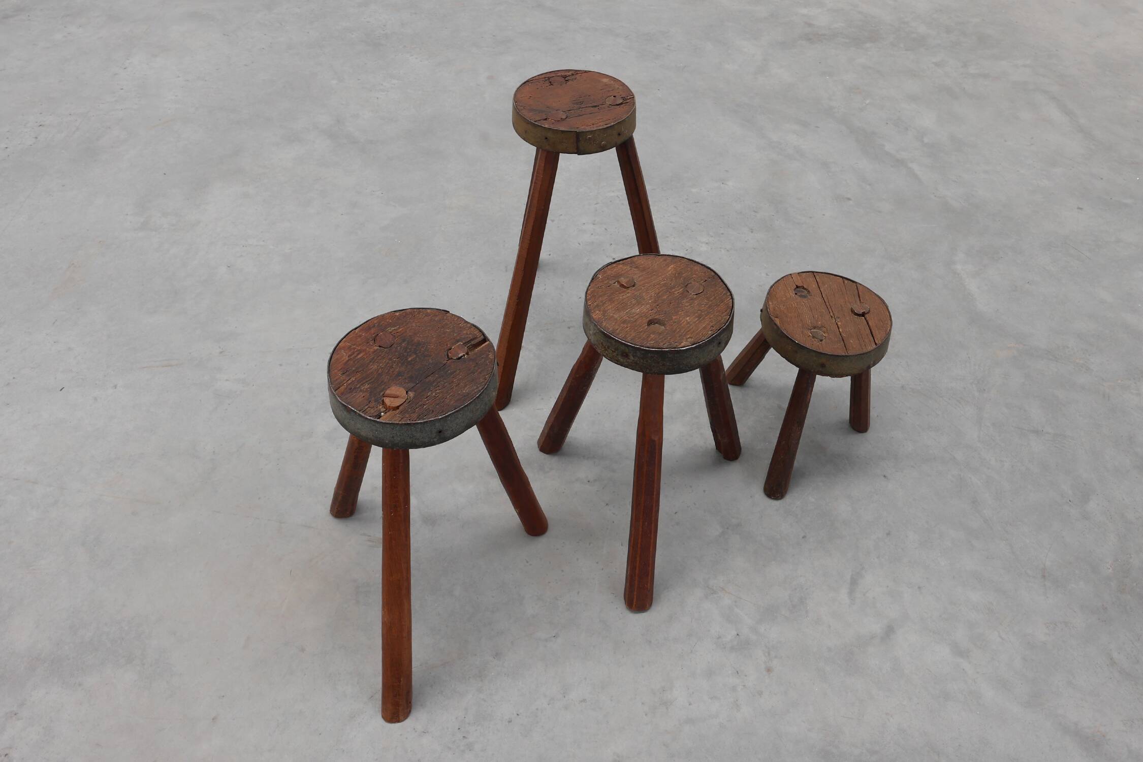 Brutalist French 1850s solid oak tripod stools with metal rim, set of 4