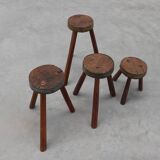 Brutalist French 1850s solid oak tripod stools with metal rim, set of 4