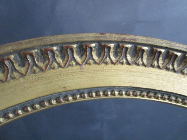 Old oval frame in gilded wood