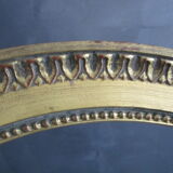 Old oval frame in gilded wood