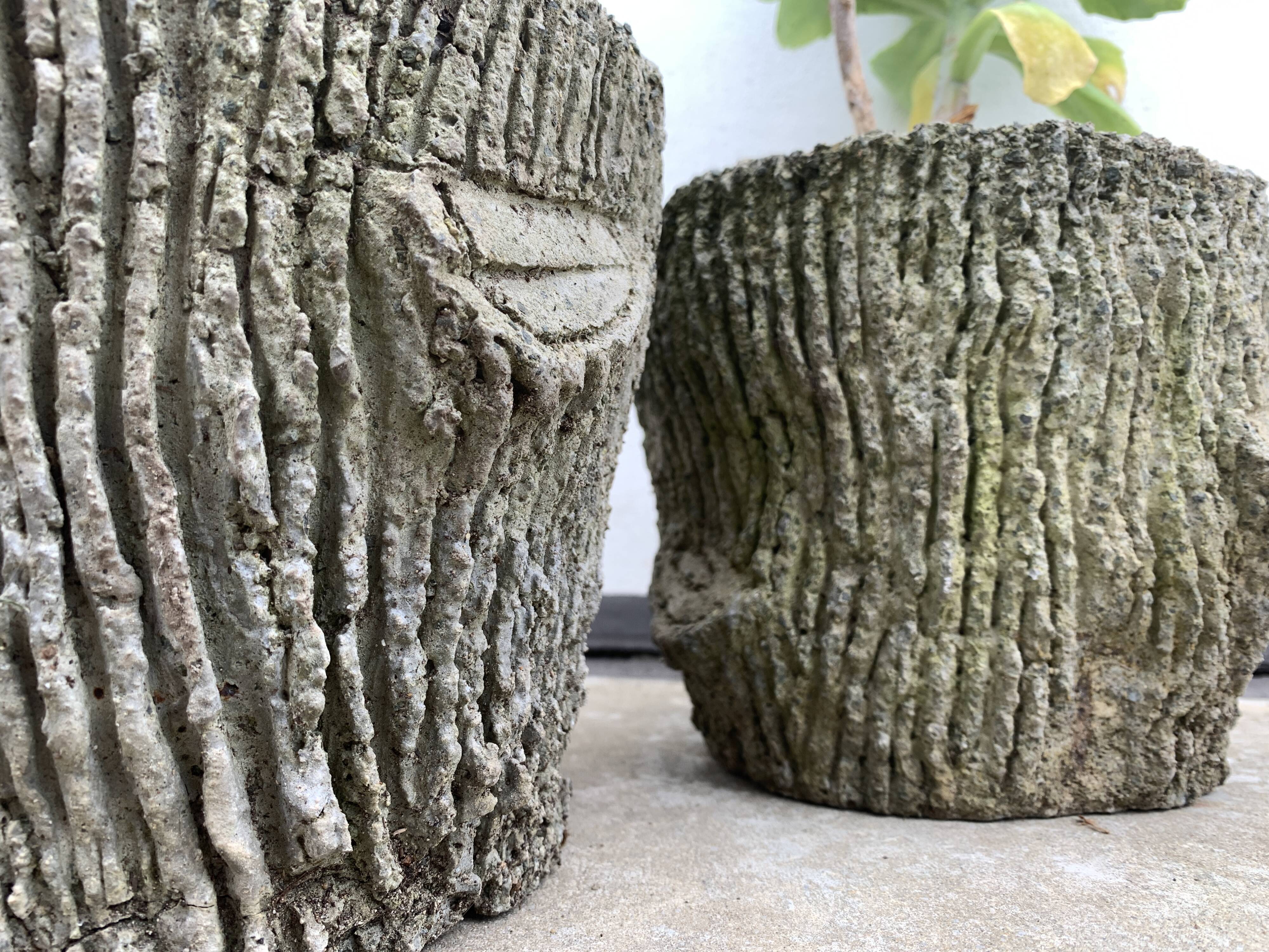 Two cement planters imitation tree trunks