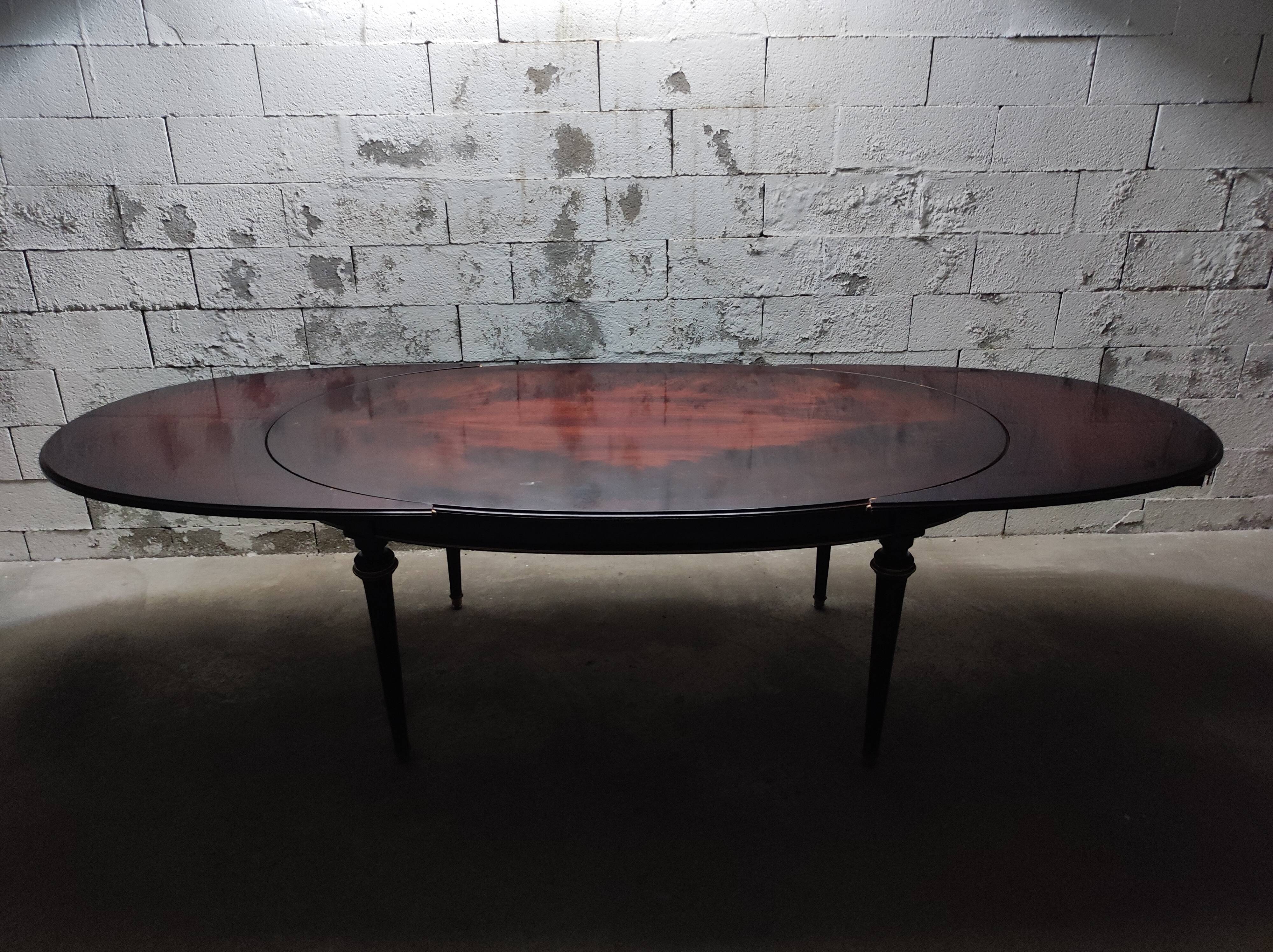 Oval Louis XVI style table with half-moon extensions.