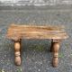 Rustic stool in solid wood with turned legs.