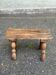 Rustic stool in solid wood with turned legs.