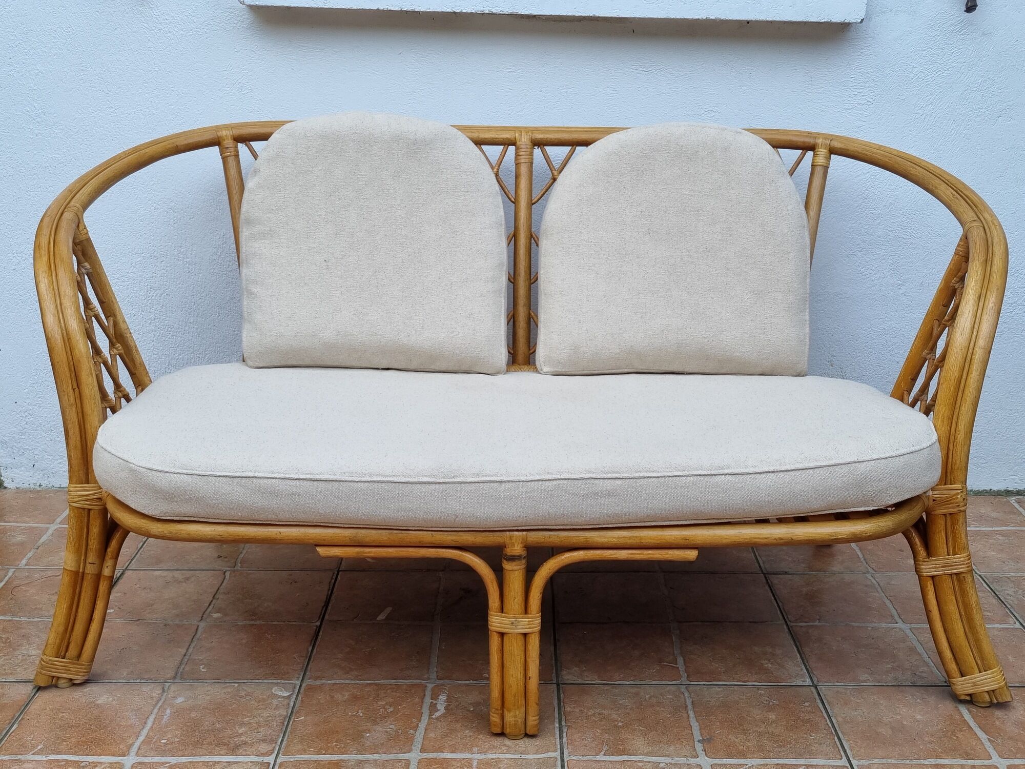 Vintage two-seater natural rattan sofa with cotton cushions, 140 cm