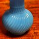 Blue opaline vase, opaque glass, wavy neck/rim, relief decoration of a bow.