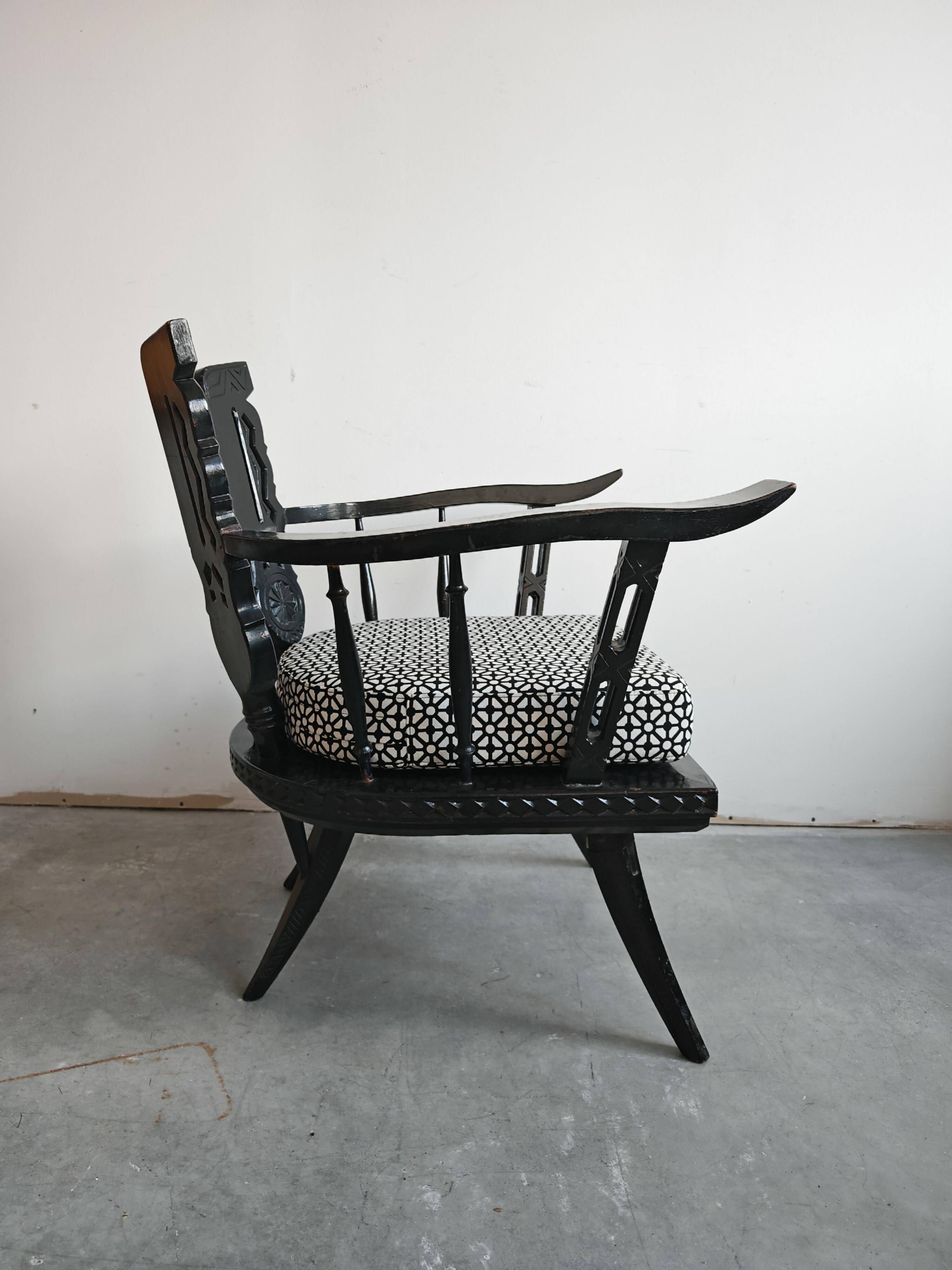 Pair of antique hand-carved armchairs in black lacquer from the 1920s.