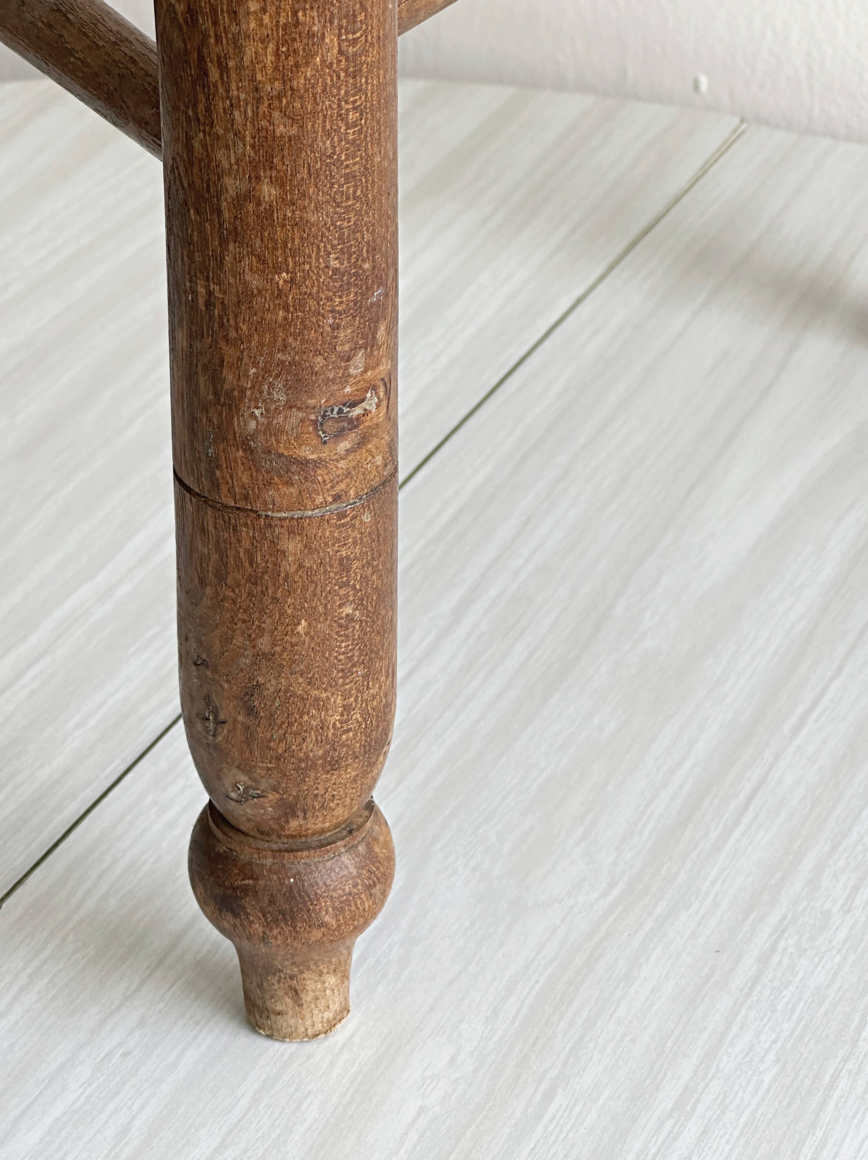Triangular turned wooden stool