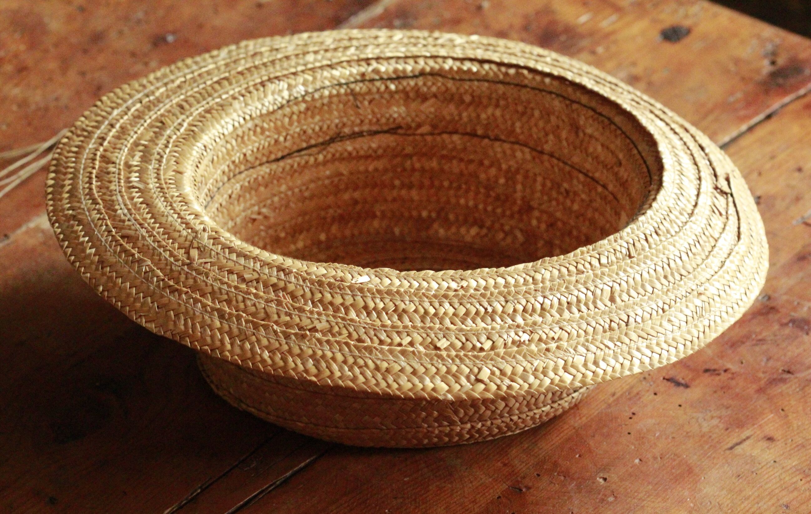 Old straw hat with black ribbon