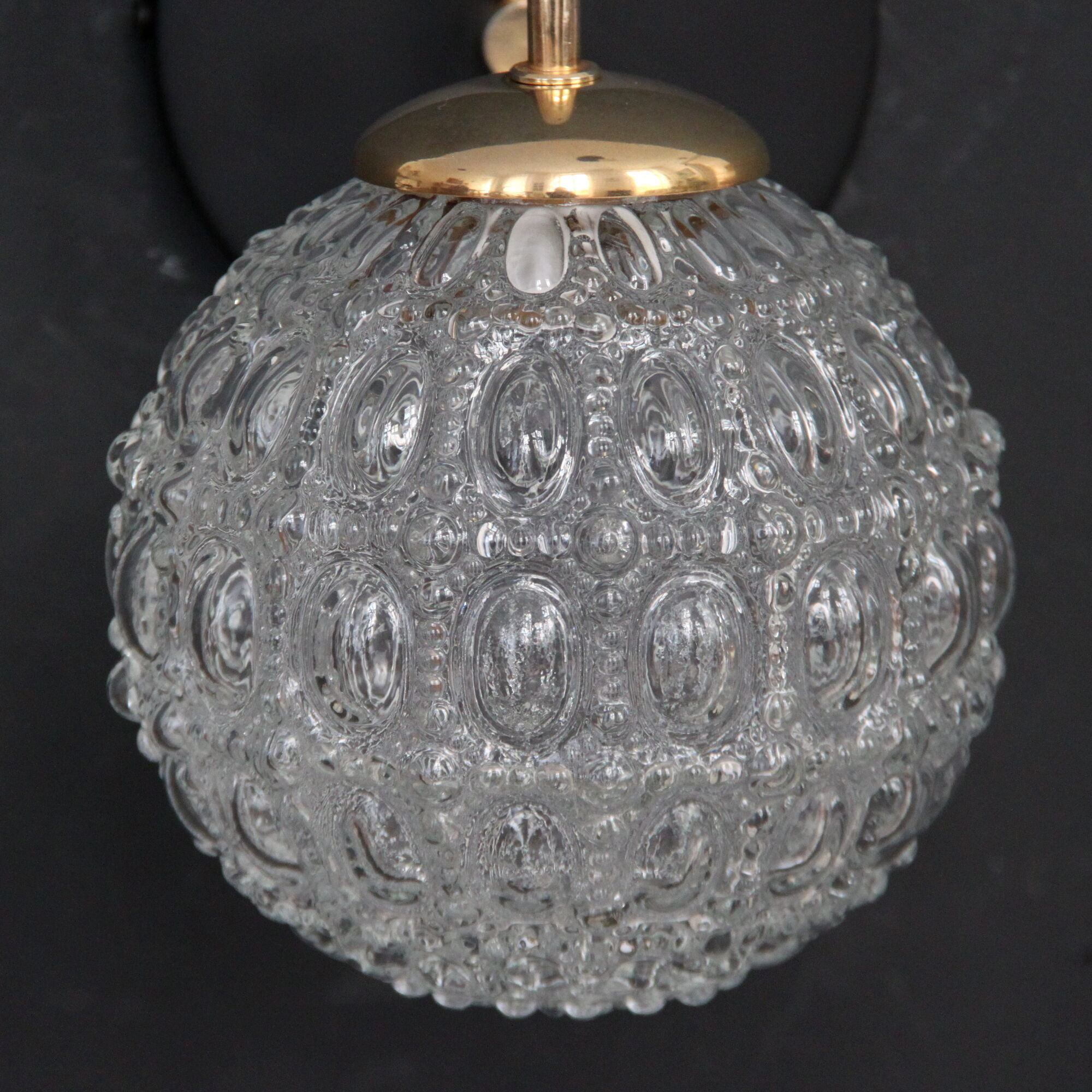 Globe wall light in moulded glass, brass swan collar, circa 1950