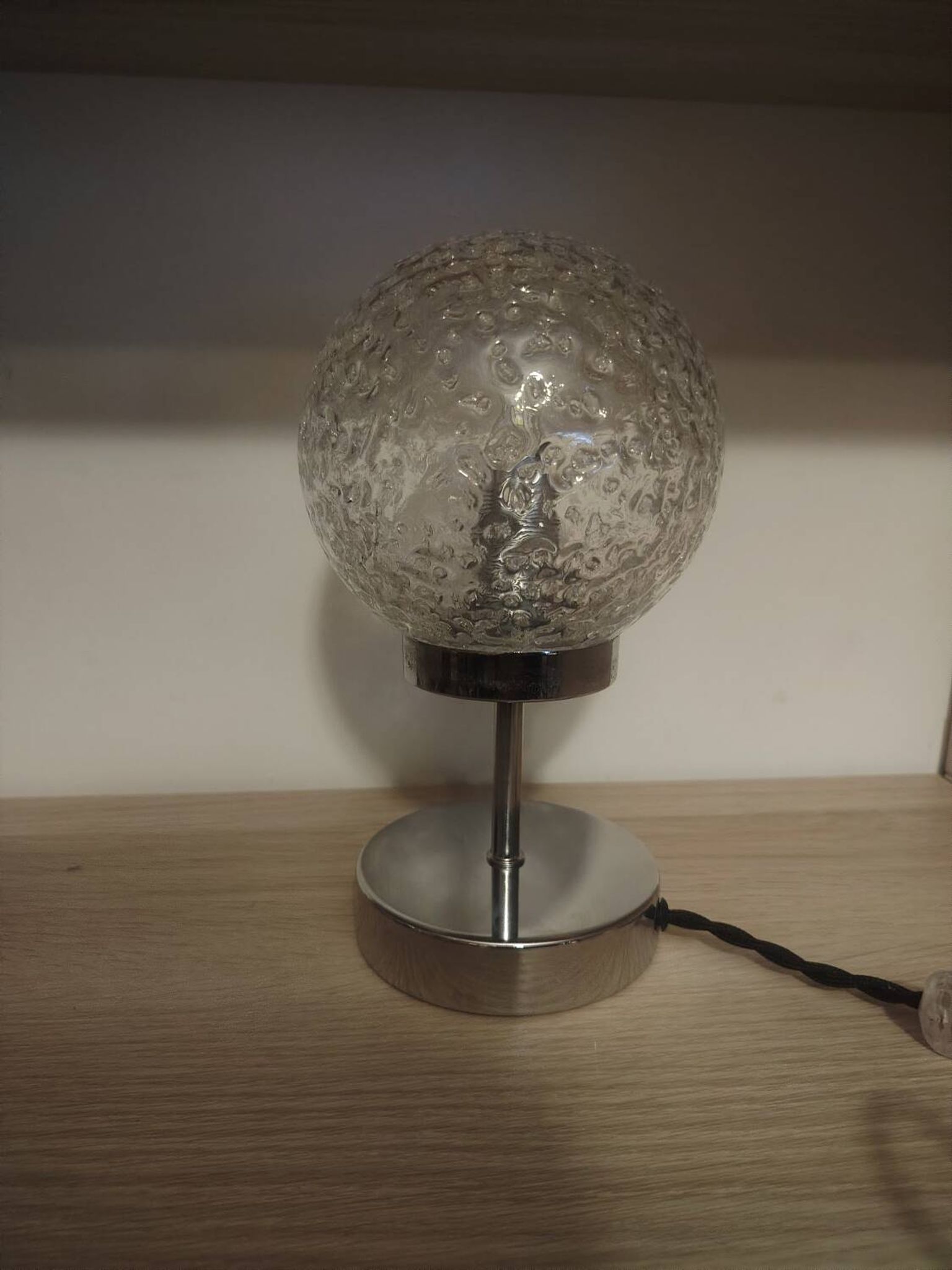 Duo of textured globe lamps with a large play of light.