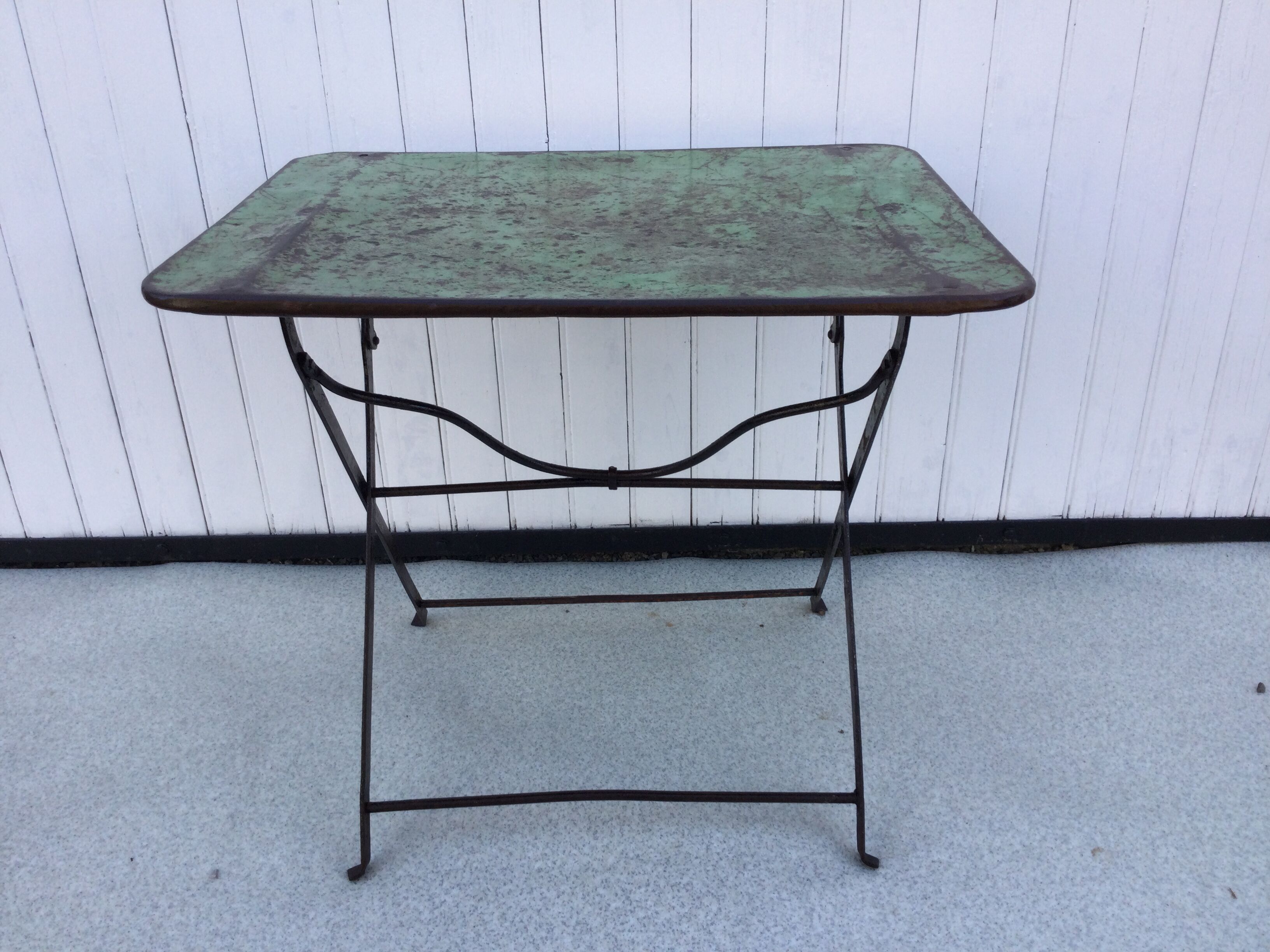 Folding riveted iron table