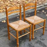 2 straw-seated chairs in light-colored solid wood