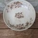 Flat serving compote dish in Terre de Fer HB & Cie with brown floral decoration.