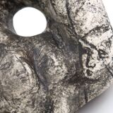 Ceramic vase sculpture decorated with faces and featuring a hole, 1980s.