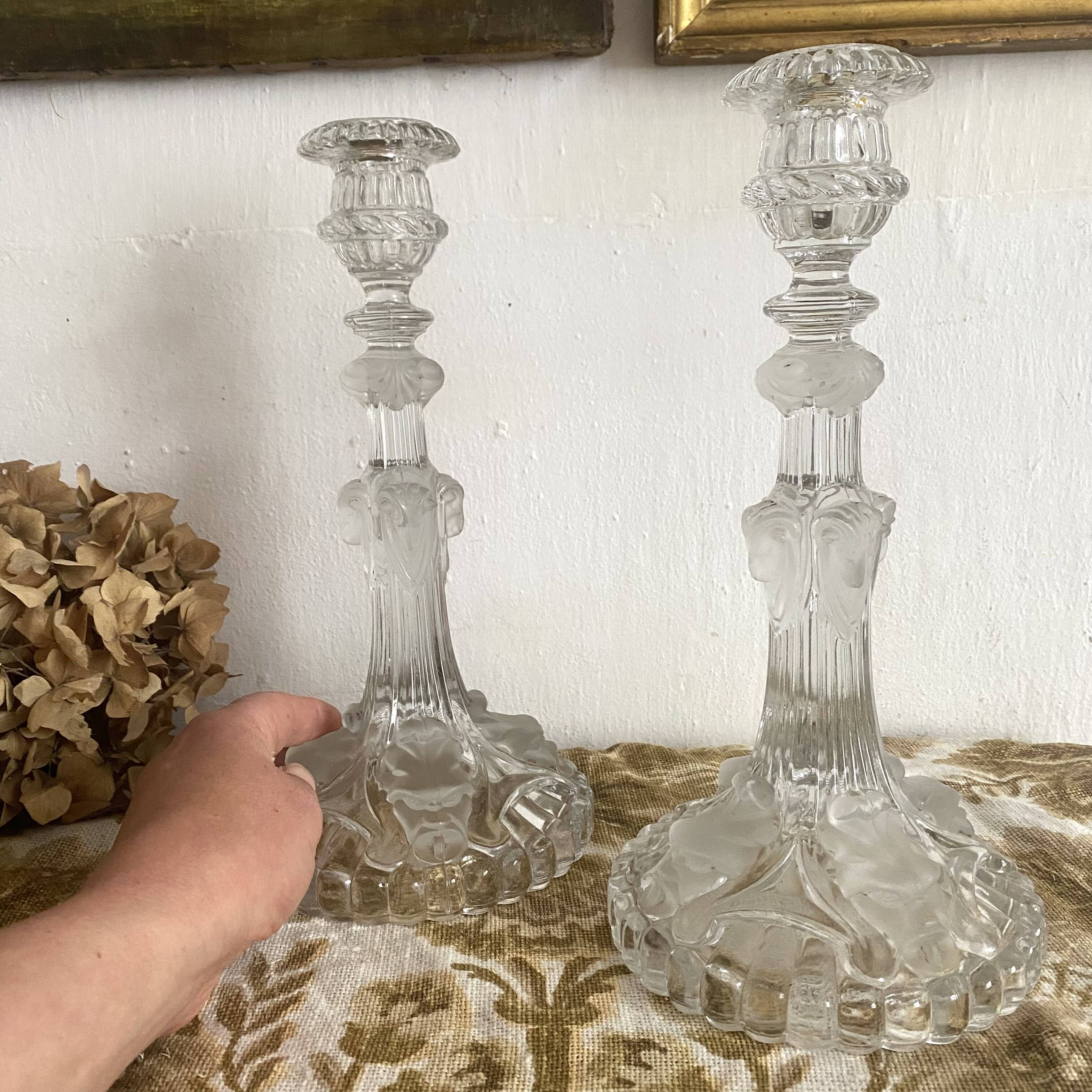 Pair of moulded glass candlesticks, ram heads and masks
