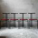 Set of 4 vintage black metal chairs with red lacquered seats.