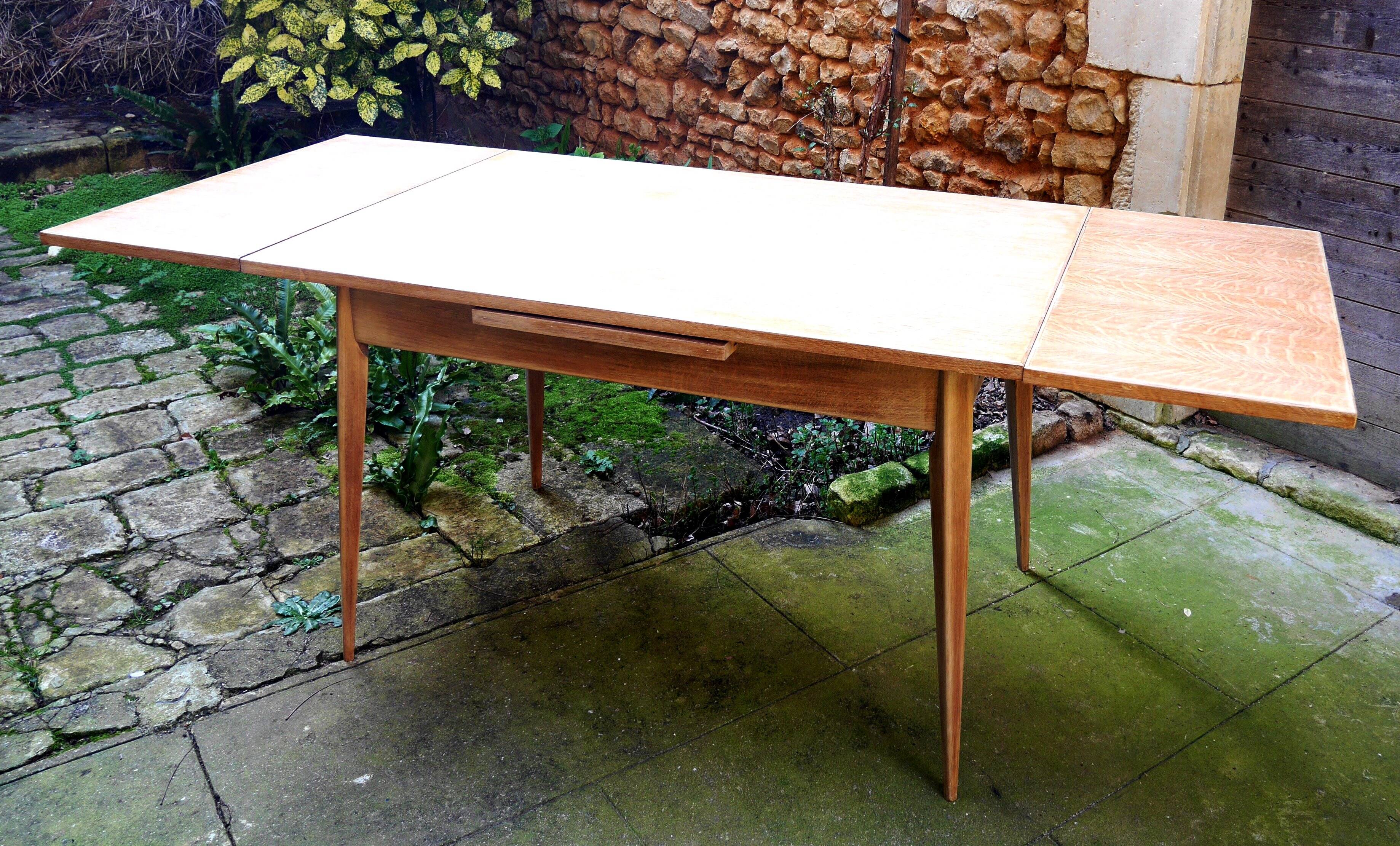 wooden dining table with compass legs and extensions