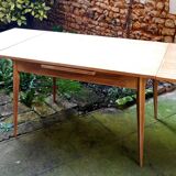 wooden dining table with compass legs and extensions