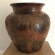 Vase or pot in brown terracotta with artistic decoration of fish.