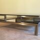 Très belle table basse en acier brossé et laiton