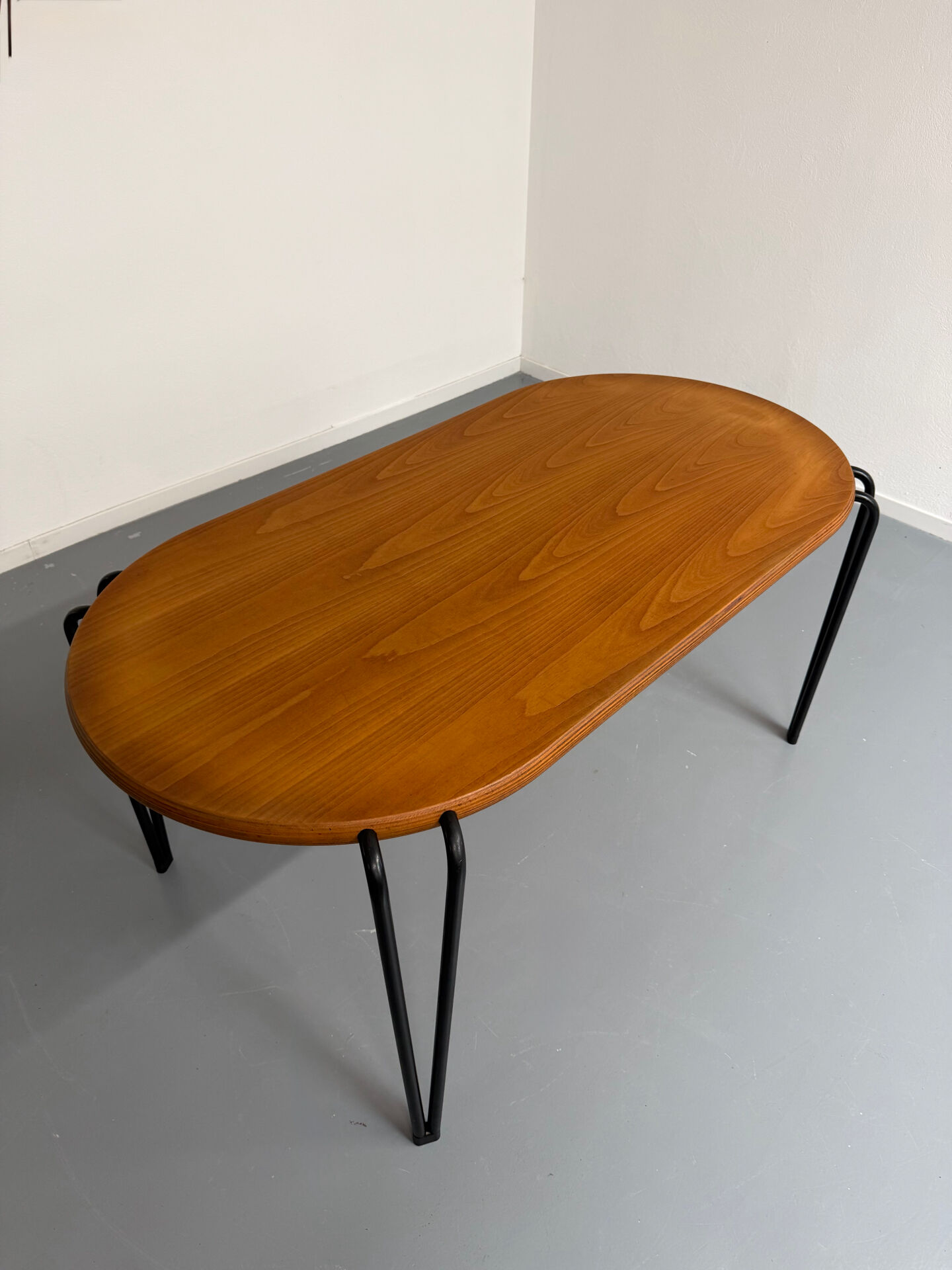Solid wood dining table with tubular legs, 1980s postmodern design.