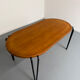 Solid wood dining table with tubular legs, 1980s postmodern design.