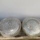 Pair of transparent round glass wall lights
