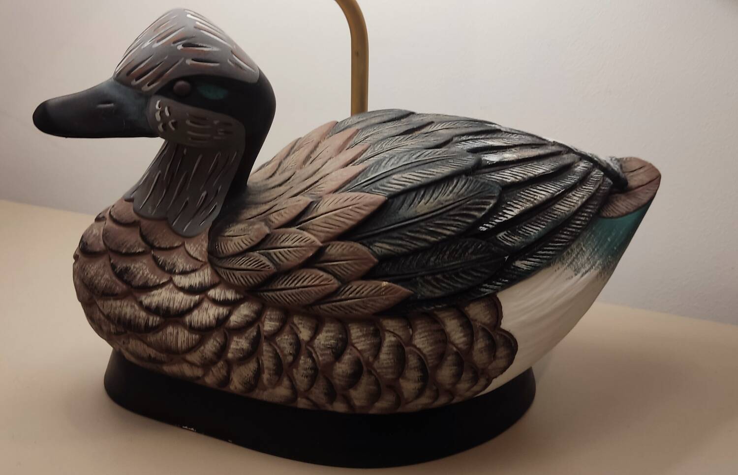 Decorative table lamp with a sculpted duck-shaped base and painted finish.