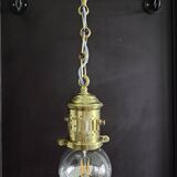 Brass pendant light with oversized LED bulb