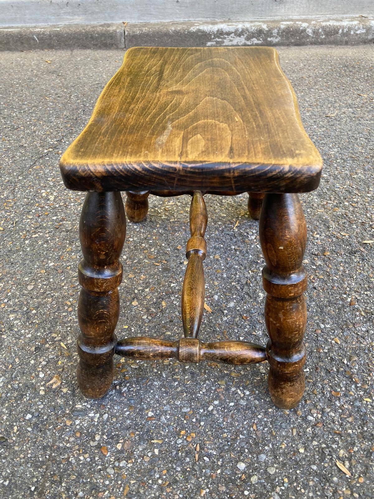 Small vintage low stool made of turned solid wood footrest 1960