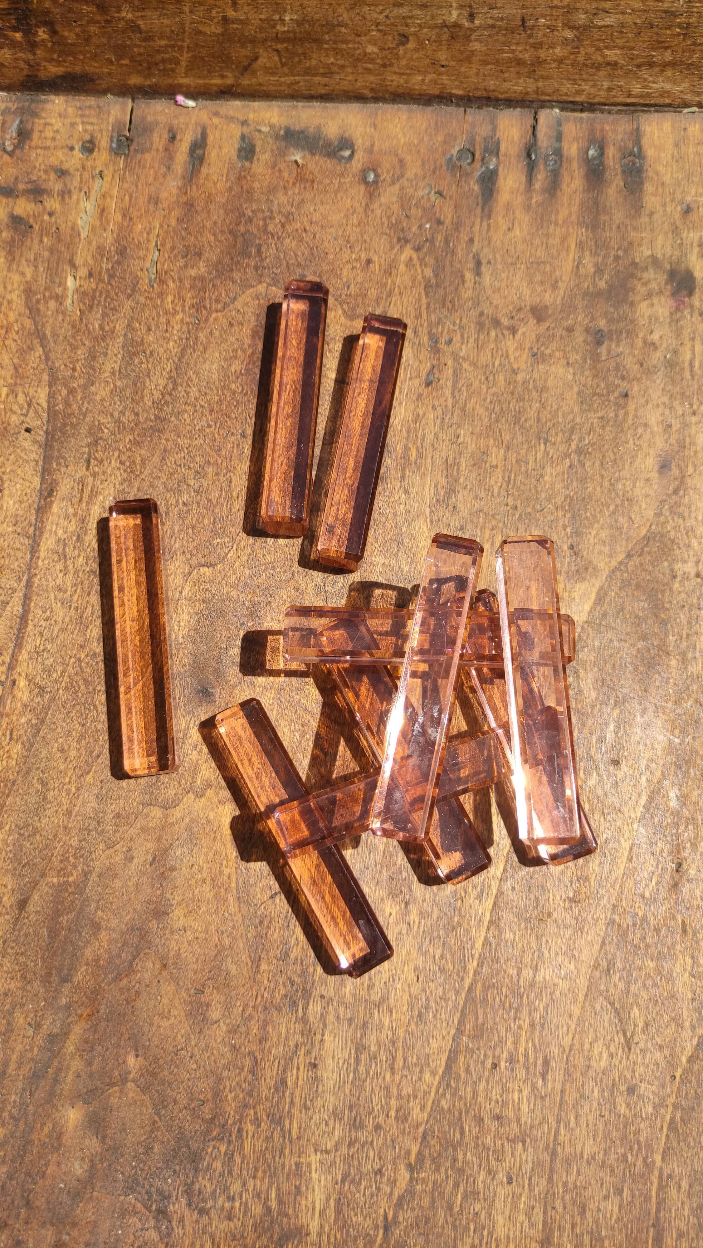 Ten pink glass knife holders