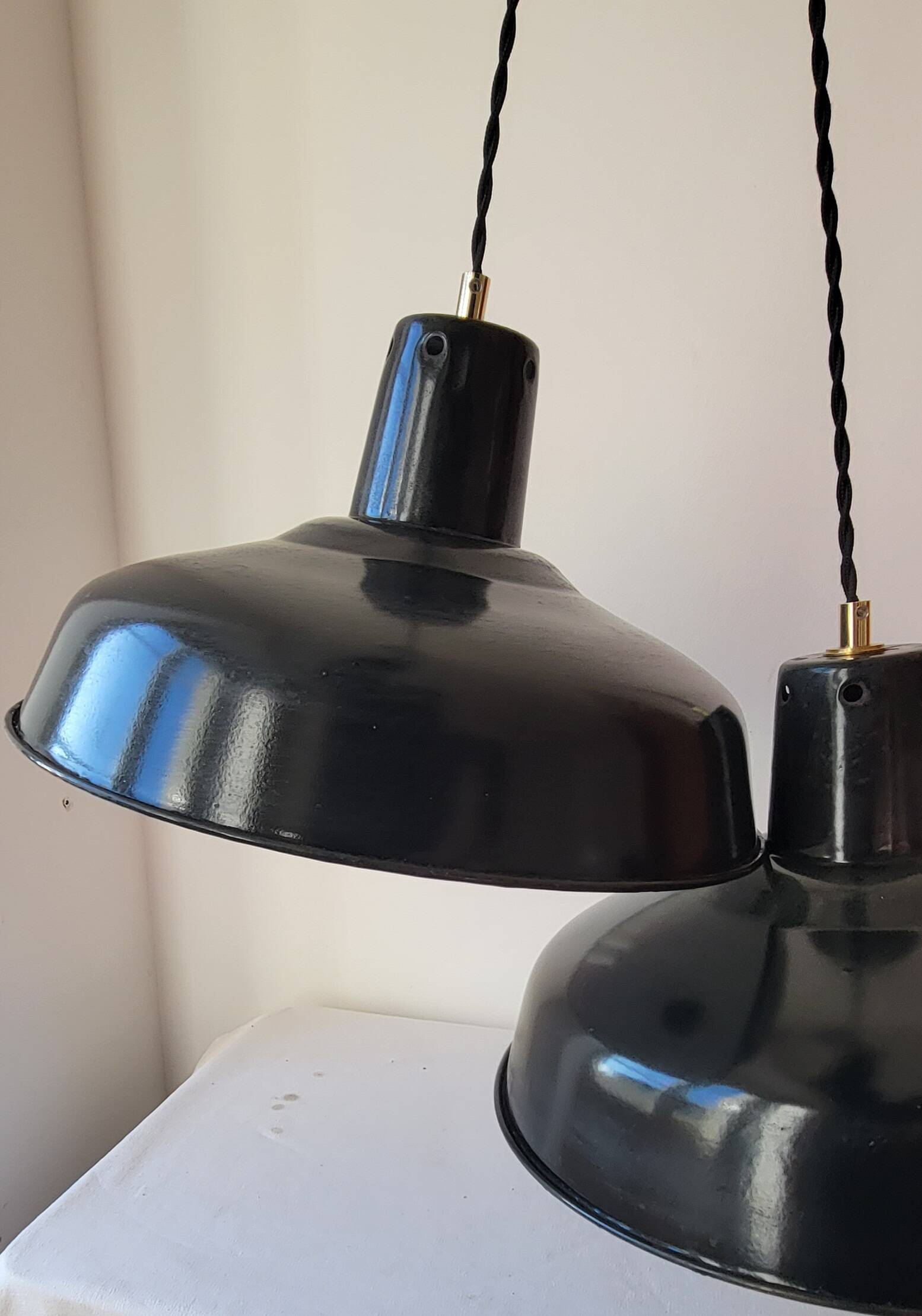 Duo of white and black enameled sheet metal pendants