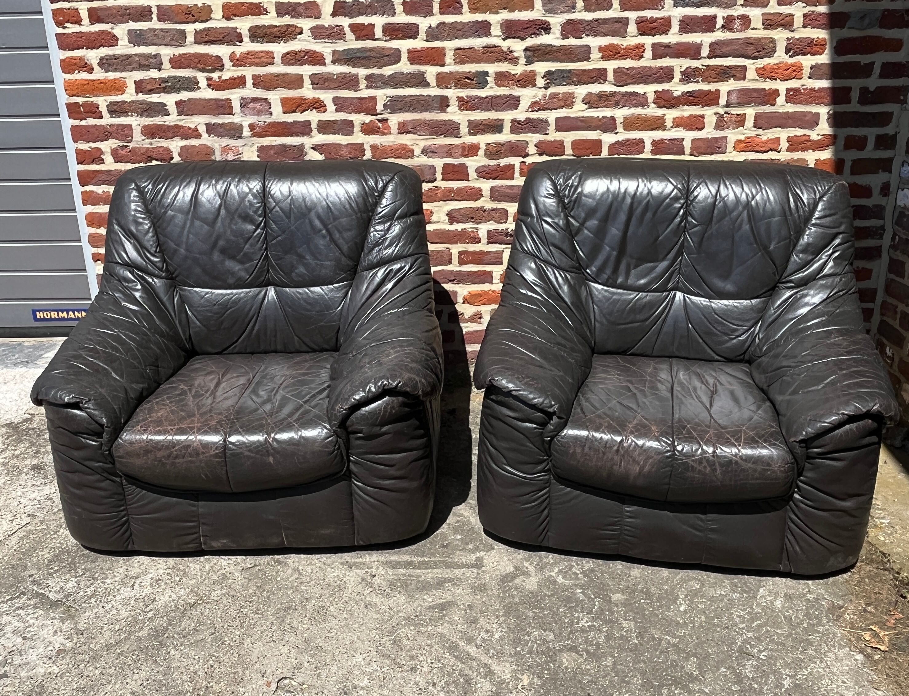 Pair of patinated leather club armchairs