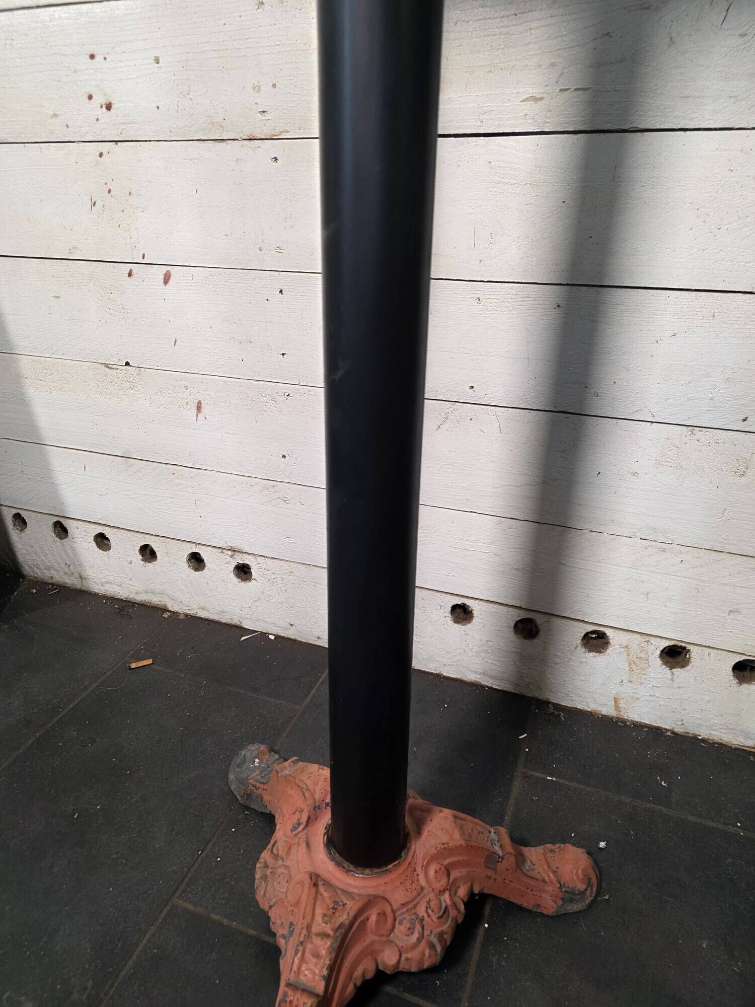Bistro standing table with marble top and cast iron base.