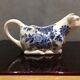 English porcelain cow-shaped sauce dish