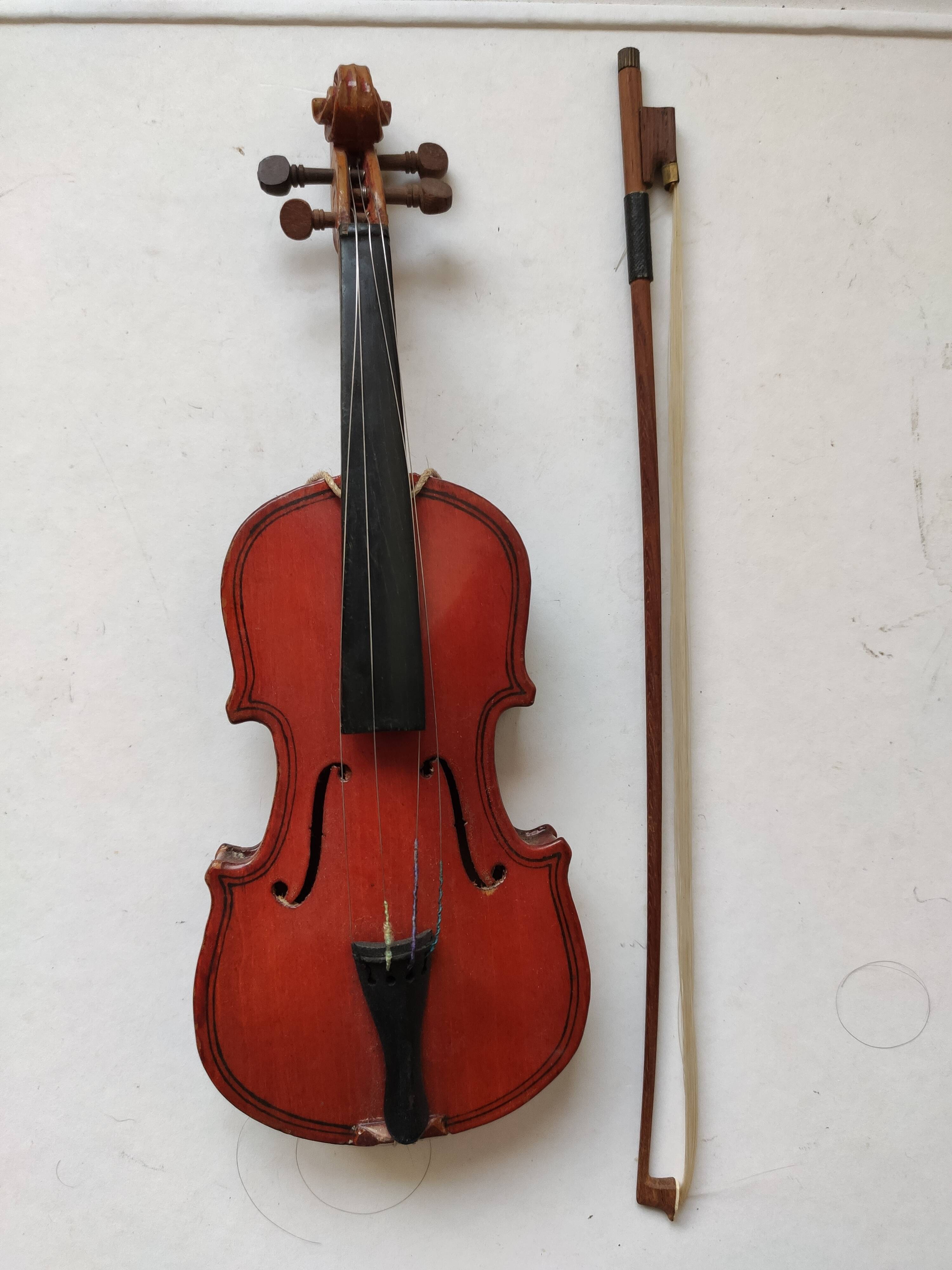 violin and decorative archer in antique varnished wood