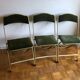 Set of three vintage green folding chairs