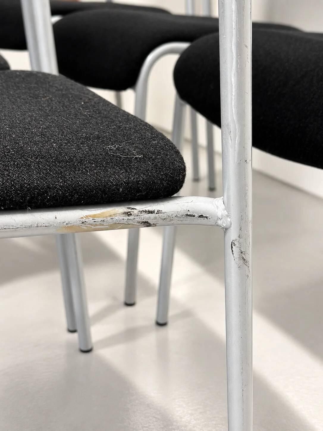 Grey steel chair and black fabric